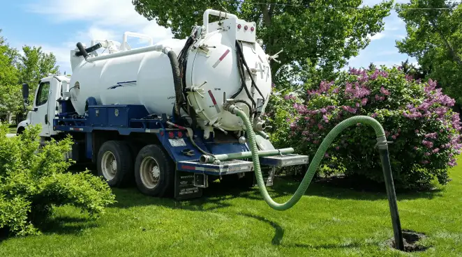 Professional vacuum truck performing residential drainage and septic maintenance in Mobile, AL