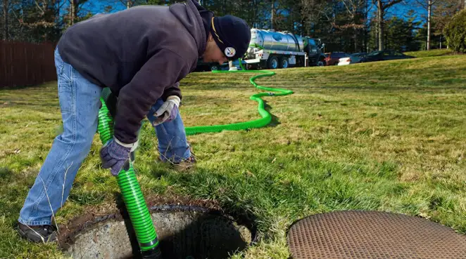 Service technician performing residential septic pumping and drainage maintenance in Mobile, AL